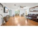 Spacious living room with hardwood floors and a view to the dining area at 2507 Lancaster Dr, Sun City Center, FL 33573