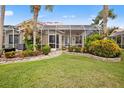 Spacious backyard oasis with screened enclosure and lush landscaping at 1217 Gorda Cay Ln, Punta Gorda, FL 33950