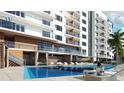 Resort-style pool with lounge chairs and cabanas; perfect for relaxing at 411 E Shore Drive # 213, Clearwater Beach, FL 33767
