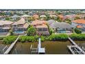 Back of house with private pool, deck, and dock, offering serene waterfront living at 1233 Acappella Ln, Apollo Beach, FL 33572