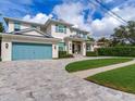 Two-story house with light-blue shutters, metal roof, and a stone driveway at 166 Baltic Cir, Tampa, FL 33606