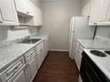 Bright kitchen features white cabinets, tile backsplash, and modern countertops at 4315 Aegean Dr # 126C, Tampa, FL 33611