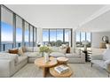 Bright living room boasts expansive windows and city views at 2912 W Santiago St # Ph2402, Tampa, FL 33629