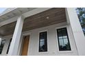 An exterior shot of a newly renovated home featuring a whitewashed brick and black trim windows at 610 Ontario Ave, Tampa, FL 33606