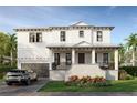 Elegant white home boasting a modern design with lush landscaping and a sleek silver car at 610 Ontario Ave, Tampa, FL 33606