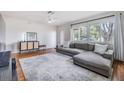 Spacious living room with hardwood floors and L-shaped sectional sofa at 205 Se Monroe N Cir, St Petersburg, FL 33703