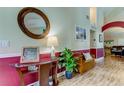 Bright entryway with hardwood floors, decorative bench, and glass-top table at 11426 Glenmont Dr, Tampa, FL 33635