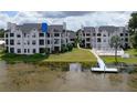 Condo community with pool, dock, and lakefront access at 3127 W Sligh Ave # 104B, Tampa, FL 33614