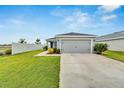 Front view of house with gray garage door at 6787 Abbywood Ln, Zephyrhills, FL 33541