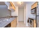 Modern kitchen featuring stainless steel appliances and wood cabinets at 10100 Sailwinds N Blvd # 205, Largo, FL 33773