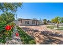 Charming single story home with brick driveway, manicured lawn and beautiful landscaping at 6750 W Flamingo S Way, St Petersburg, FL 33707