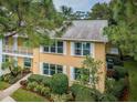 Charming condo with white shutters, balcony, and attractive landscaping at 2156 Masters Ct # 2156, Dunedin, FL 34698