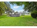 Spacious backyard with above ground pool and large grassy area at 2419 Roxbury Cir, North Port, FL 34287