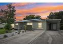 A single-story home with solar panels and a spacious driveway at 2419 Roxbury Cir, North Port, FL 34287