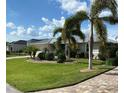 Single-story house with a metal roof, and landscaped yard at 132 Peckham Se St, Port Charlotte, FL 33952