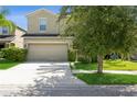 Two-story house with attached garage and landscaping at 1411 Trailwater St, Ruskin, FL 33570