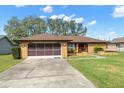 Single story home with brown roof and red door at 8227 Rhanbuoy Rd, Spring Hill, FL 34606