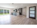 Modern kitchen with island, stainless steel appliances, and sliding glass doors at 1227 Arden Ave, Clearwater, FL 33755