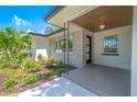Modern home front porch with brick facade and landscaping at 1227 Arden Ave, Clearwater, FL 33755