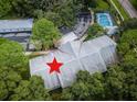 Aerial view of condo building, pool, and surrounding landscape at 2156 Masters Ct # 2156, Dunedin, FL 34698