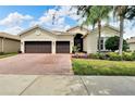 Two-story home with a two-car garage and well-manicured lawn at 16005 Cape Coral Dr, Wimauma, FL 33598