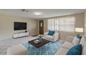 Bright living room featuring white sofas and a modern coffee table at 7506 Cumber Dr, New Port Richey, FL 34653