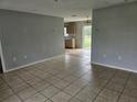 Open living room with tiled floors and kitchen views at 36131 Pine Bluff Loop, Dade City, FL 33525