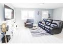 Bright living room features a large sectional sofa and a cozy recliner at 8114 N Edison Ave, Tampa, FL 33604