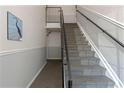 Interior view of a carpeted staircase with metal railings at 105 Pompano Se Dr # A, St Petersburg, FL 33705