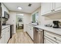 Condo kitchen with white cabinets and stainless steel appliances at 36750 Us Highway 19 N # 05102, Palm Harbor, FL 34684