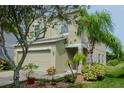 Two-story house with a landscaped yard and attached garage at 1307 Pasadena Bloom Ln, Ruskin, FL 33570
