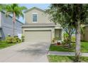 Two-story house with a landscaped yard and attached garage at 1307 Pasadena Bloom Ln, Ruskin, FL 33570