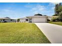 House exterior with driveway and grassy lawn at 1617 Heather Pl, Palm Harbor, FL 34684