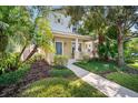 Two-story house with blue door, walkway, and lush landscaping at 4820 Forest Creek Trl, Parrish, FL 34219