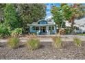 Quaint light blue house with manicured landscaping, creating curb appeal at 2111 Burlington N Ave, St Petersburg, FL 33713