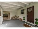Welcoming covered front porch area with a charming front door and room to sit and relax at 12318 Woodleigh Ave, Tampa, FL 33612