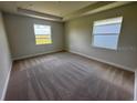 Neutral bedroom featuring a spacious layout, plush carpet, and natural light from two bright, picturesque windows at 4303 Pullet Ct, Lakewood Ranch, FL 34211