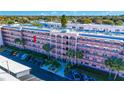 Condo building with palm trees, manicured landscaping and ample parking at 5521 80Th N St # 310, St Petersburg, FL 33709