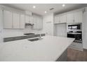 Bright kitchen with granite countertops, stainless steel appliances, and plentiful cabinet storage at 6218 Hidden Branch, Apollo Beach, FL 33572