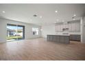 Open-concept living space with tile flooring, recessed lighting, and sliding glass doors to the backyard at 6218 Hidden Branch, Apollo Beach, FL 33572