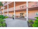 Condominium building entrance with walkway and landscaping at 5521 80Th N St # 310, St Petersburg, FL 33709