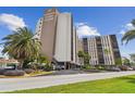 Paradise Island Towers building exterior, showing parking and landscaping at 10355 Paradise Blvd # 702, Treasure Island, FL 33706