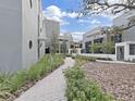 Landscaped courtyard with brick pathways and modern building exteriors at 3030 W Santiago St # 4, Tampa, FL 33629