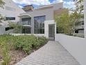 Modern building entrance with landscaped walkway and private courtyard at 3030 W Santiago St # 4, Tampa, FL 33629