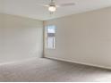 Spacious bedroom with neutral walls, carpeted floors, and a large window at 2110 Purple Orchid Pl, Ruskin, FL 33570