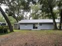 Backyard view showing a freshly painted house with a shed at 504 Maydell Dr, Tampa, FL 33619