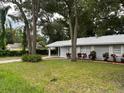 Newly painted house with a carport and well-maintained lawn at 504 Maydell Dr, Tampa, FL 33619