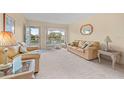 Living room with light beige couches and carpet at 2358 Ecuadorian Way # 56, Clearwater, FL 33763