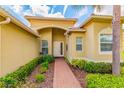 Front entry of a single Gathering house with a brick walkway at 4963 Sapphire Sound Dr, Wimauma, FL 33598