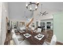 Bright dining room with a large table, chandelier, and view into the kitchen at 2220 Linda Ln, Lutz, FL 33558